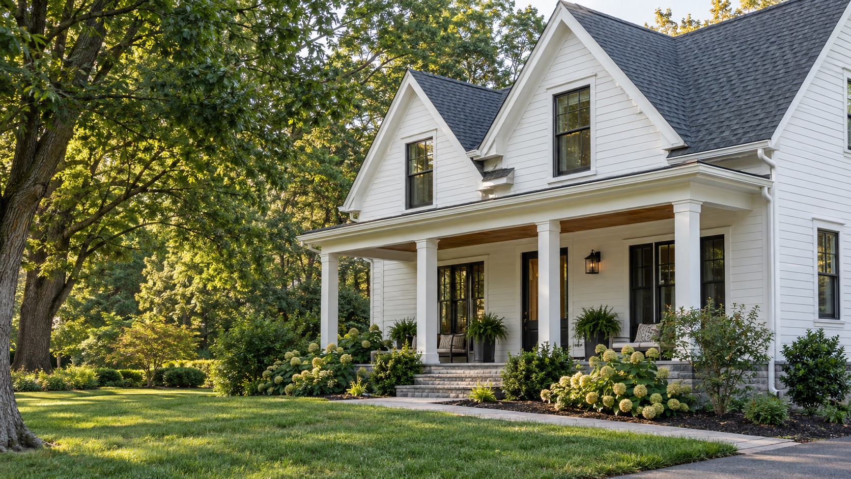 White home with seamless gutters, a covered porch, and a green lawn